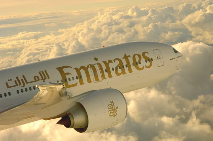 Emirates Airlines Plane at the Skies on a golden evening lights- High Quality Image Emirates Airlines Plane at the Skies on a golden evening lights- High Quality Image